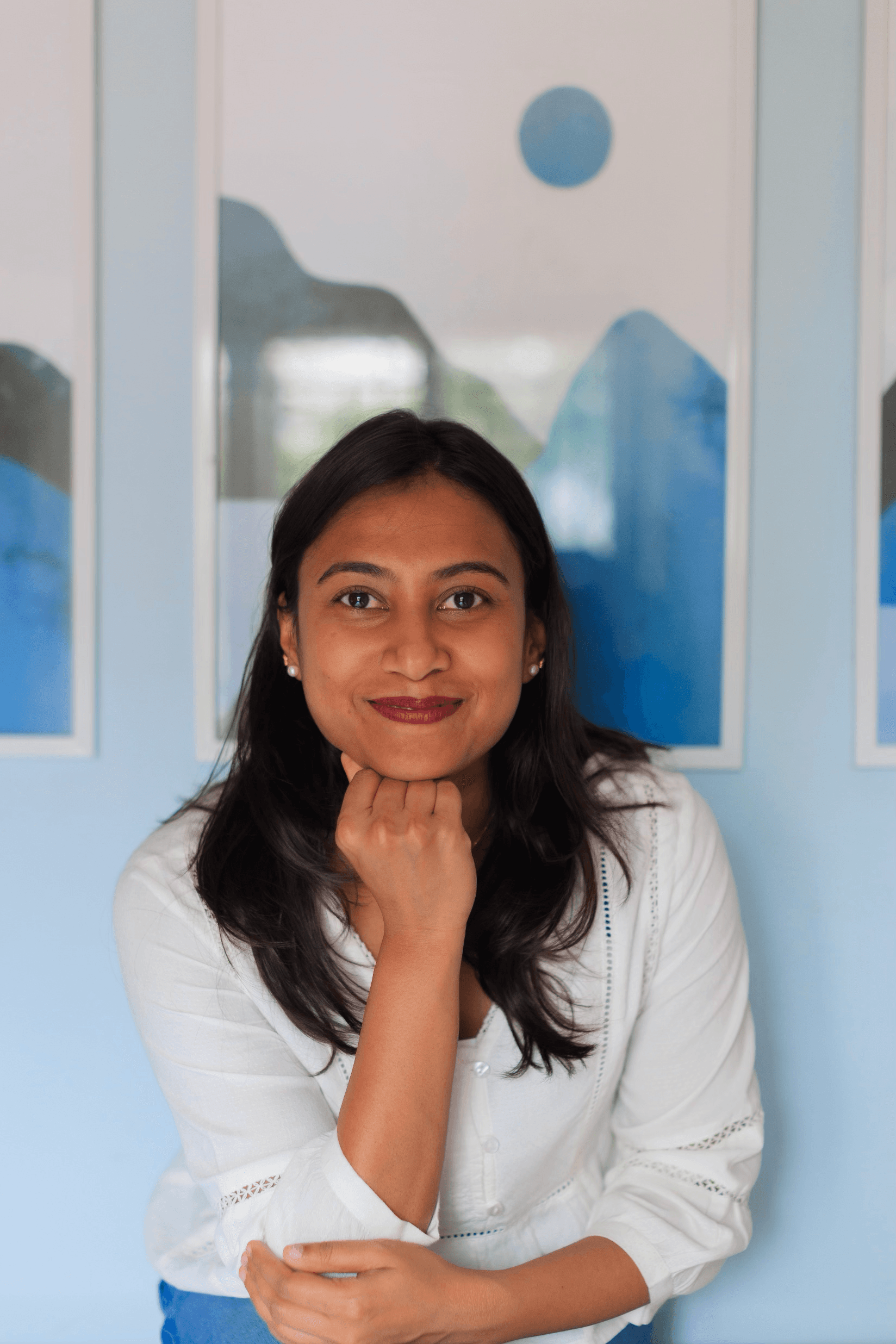 Neha Anna Johny smiling with hands gently resting near her chin